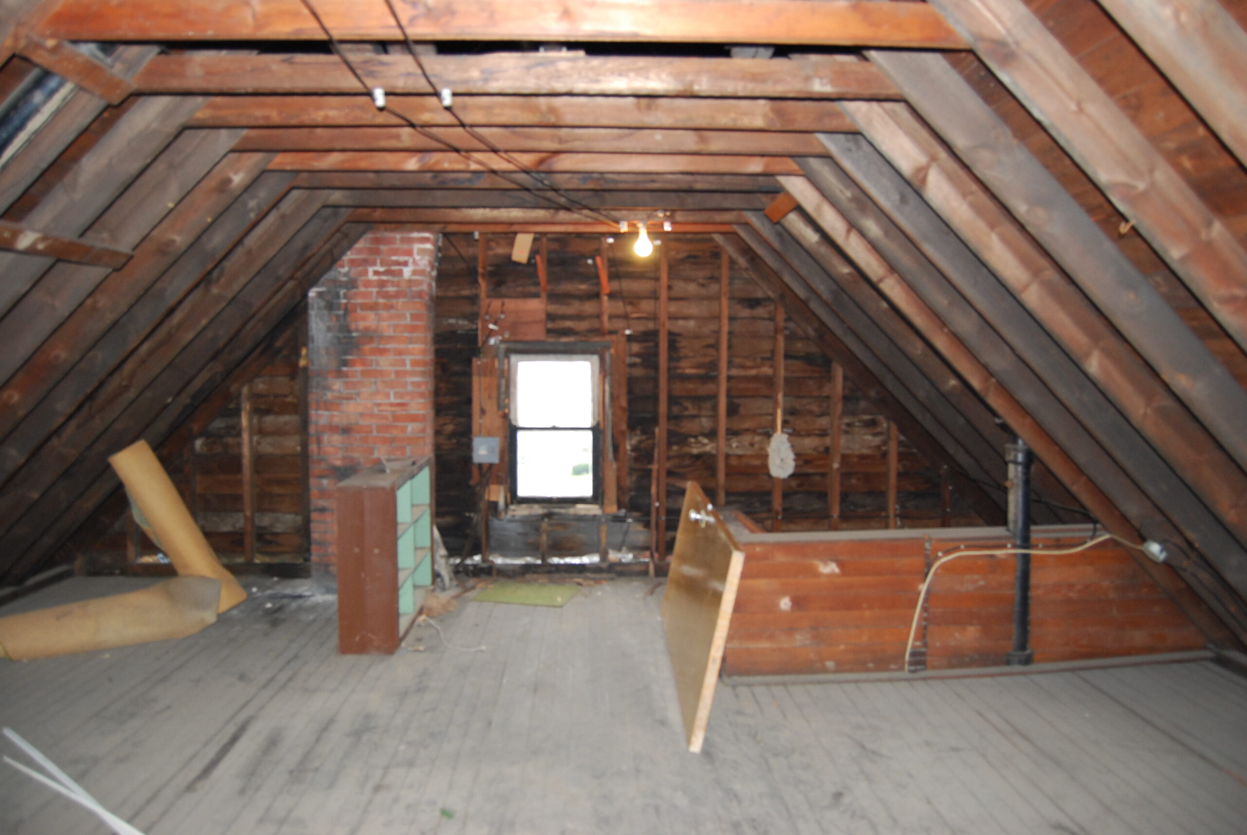 "Unfinished attic interior showing pitched roof timbers"